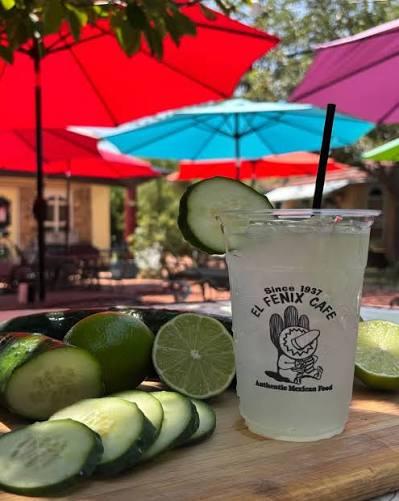 House cucumber agua fresca served with fresh limes on the patio