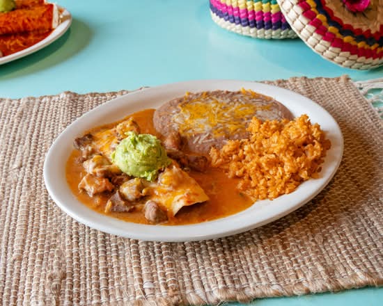 Beef enchilada plate with guacamole, rice and beans